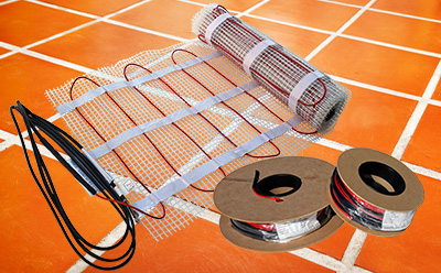ComfortTile floor heating mats and cable on spools.
