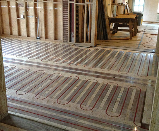 The panels of a hydronic floor heating system installed.