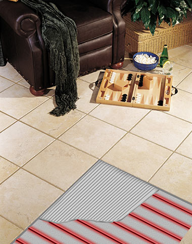 Photo of heated floor with cutaway showing the heat cable and thinset under the tile. Heated floor with cutout showing heat cable and thin set.