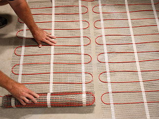 Electric floor heating mats being installed.