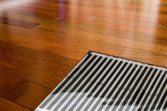 FilmHeat heating element shown under a hardwood floor.
