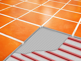 A heated tile floor with cutaway, showing the thin floor heating cable.
