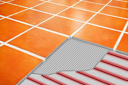Heated floor with cutout showing heat cable and thin set.